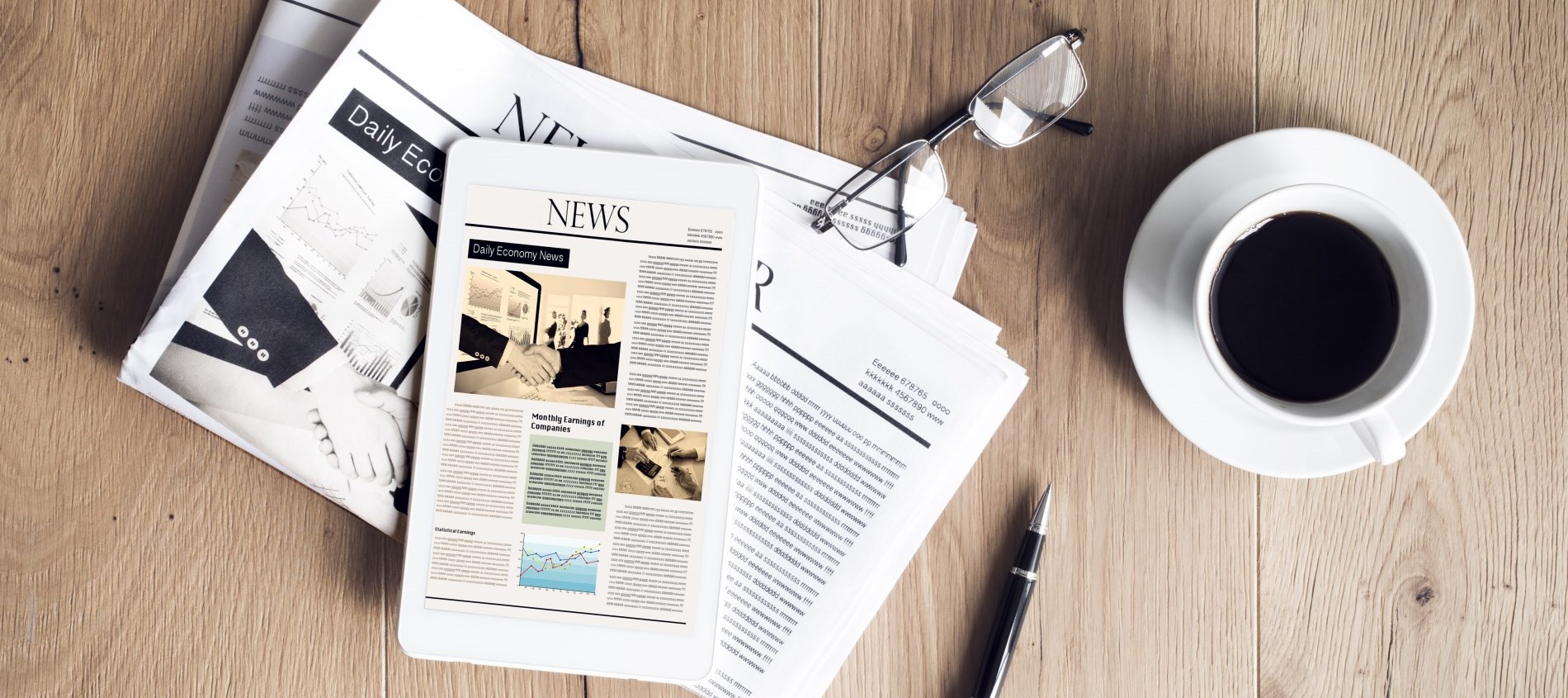 Newspaper, coffee, glasses and pen on table