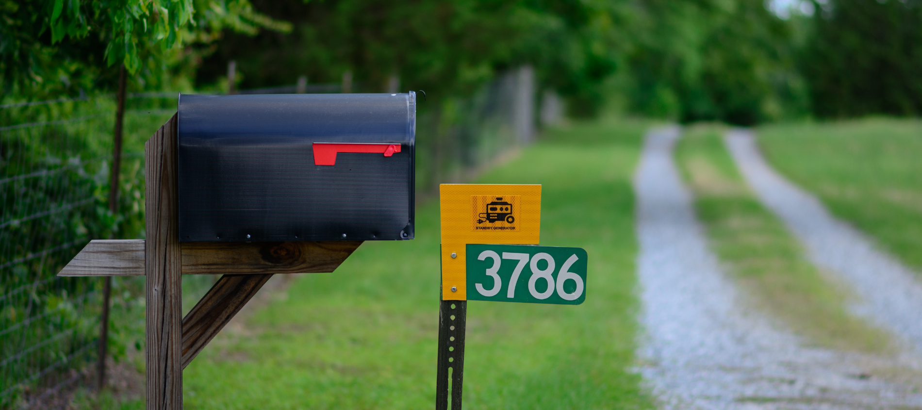 Picture of a driveway with mailbox and alternate power sign