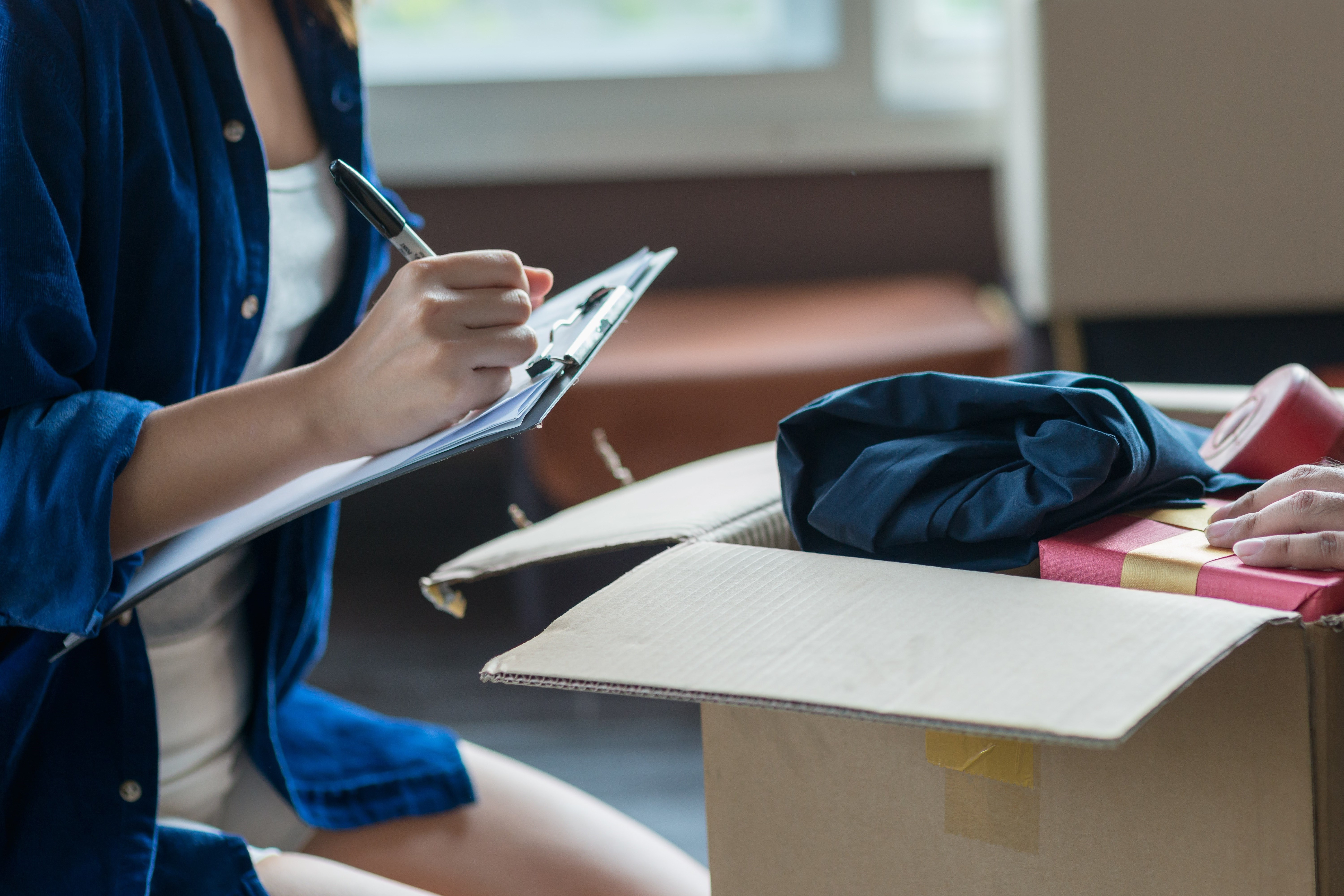 Moving boxes filled with a person filling out forms