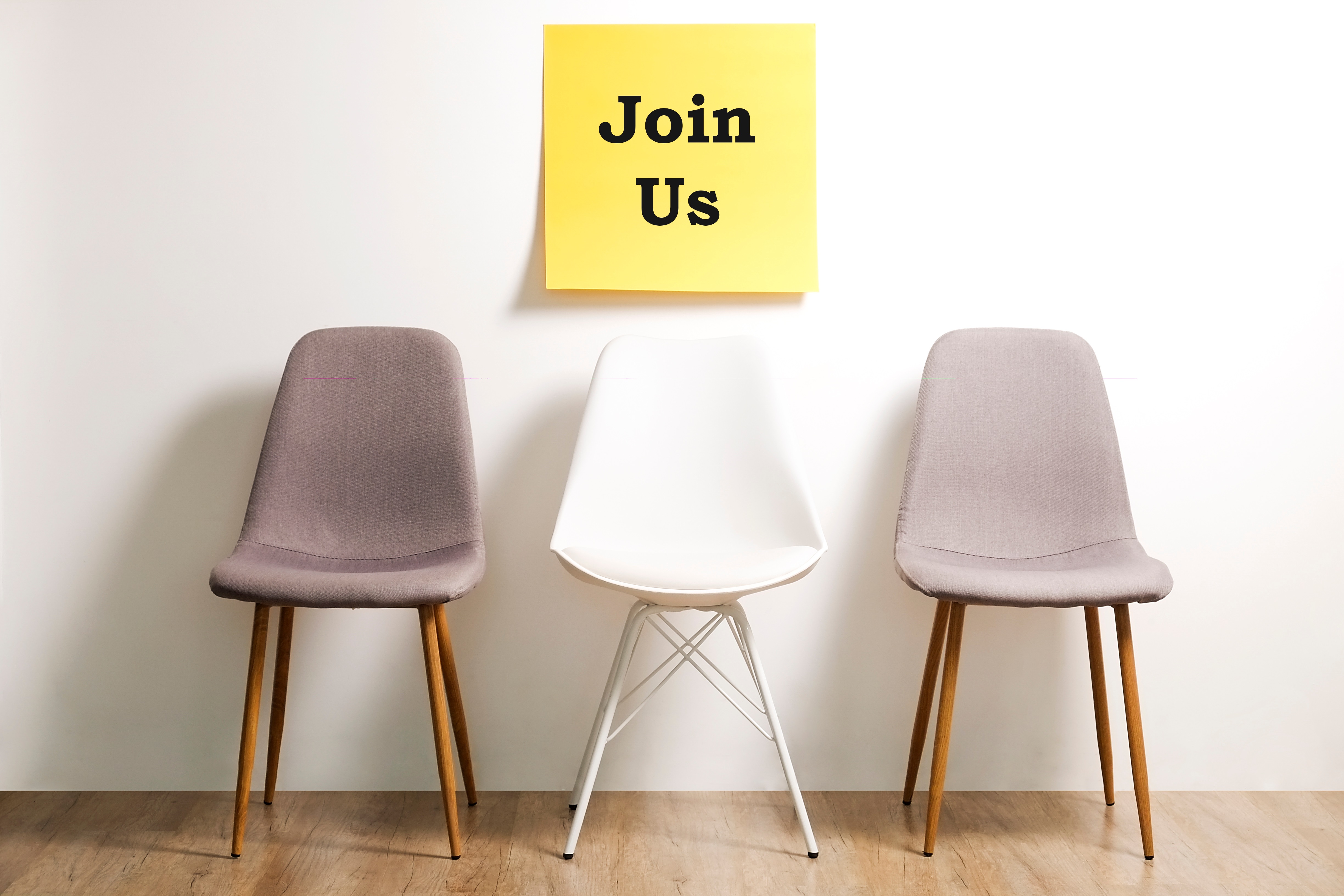 Three chairs with a sign stating 'Join Us'