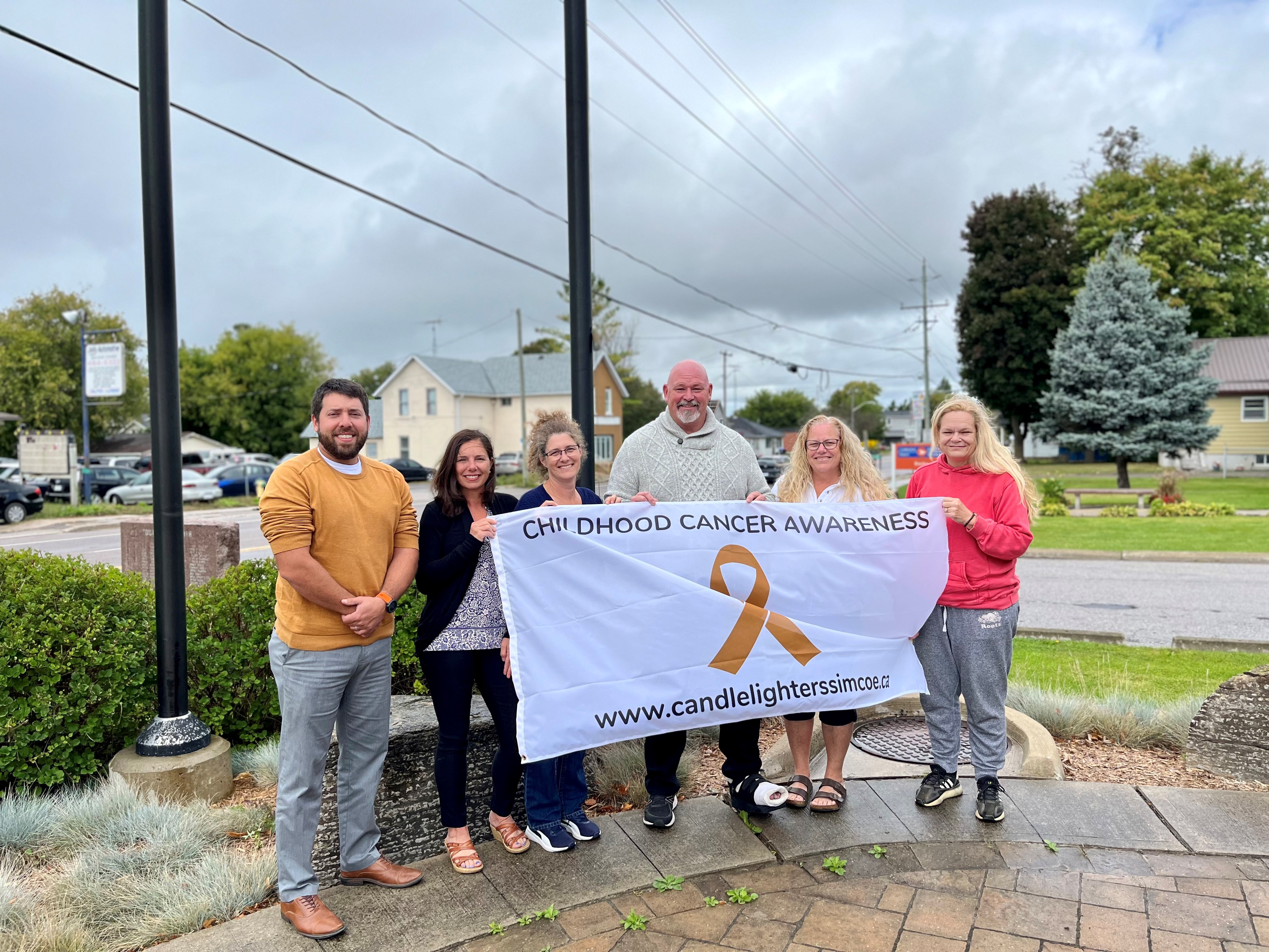 Picture of flag raising for Childhood Cancer Awareness month