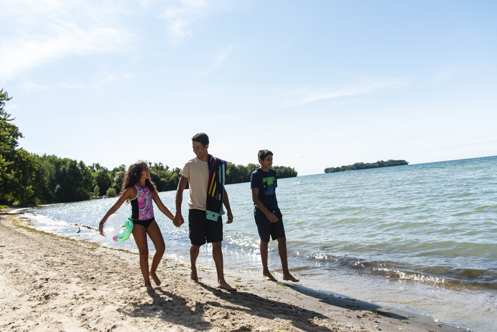 A picture of three people walking the beach