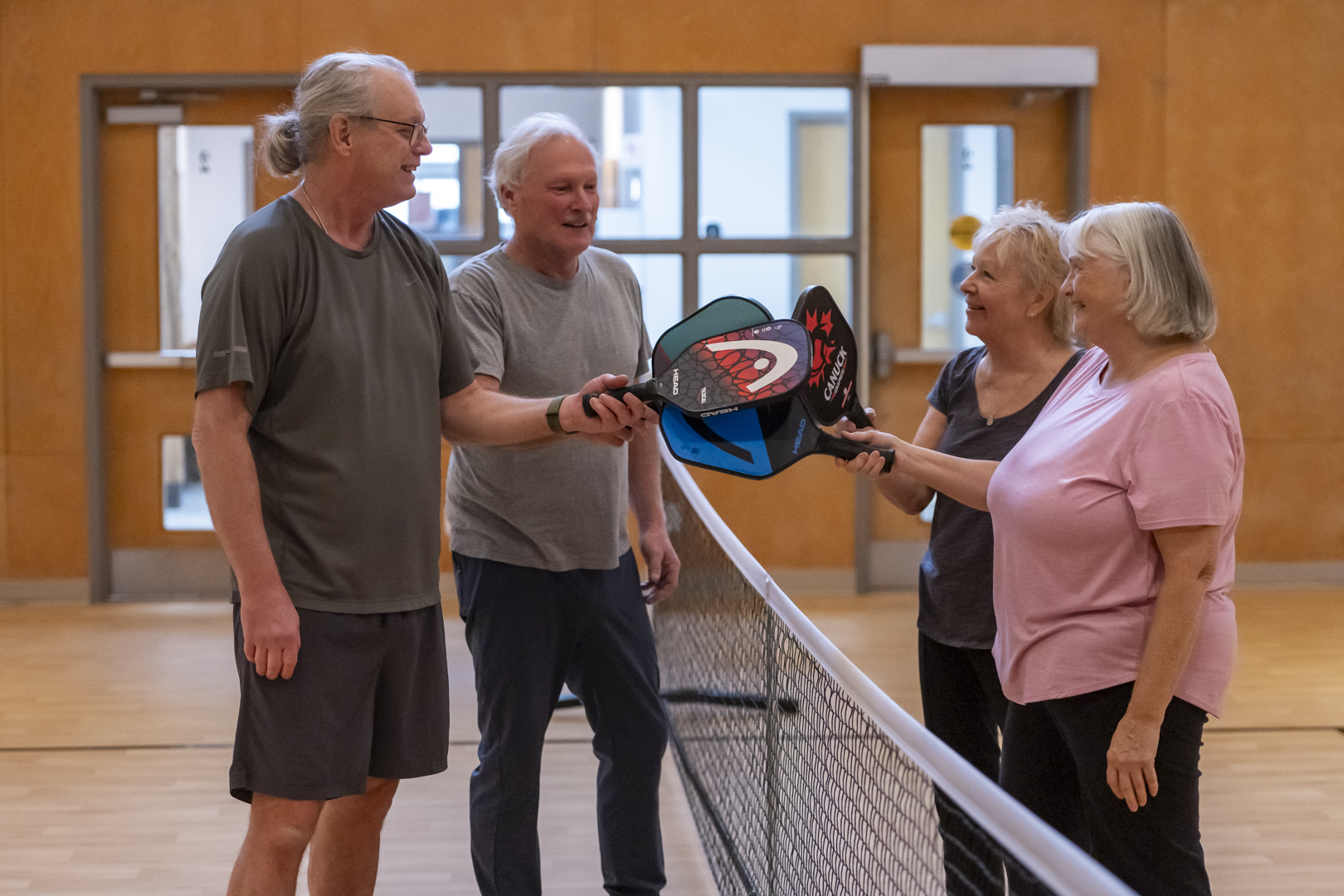 Four older adults playing pickelball