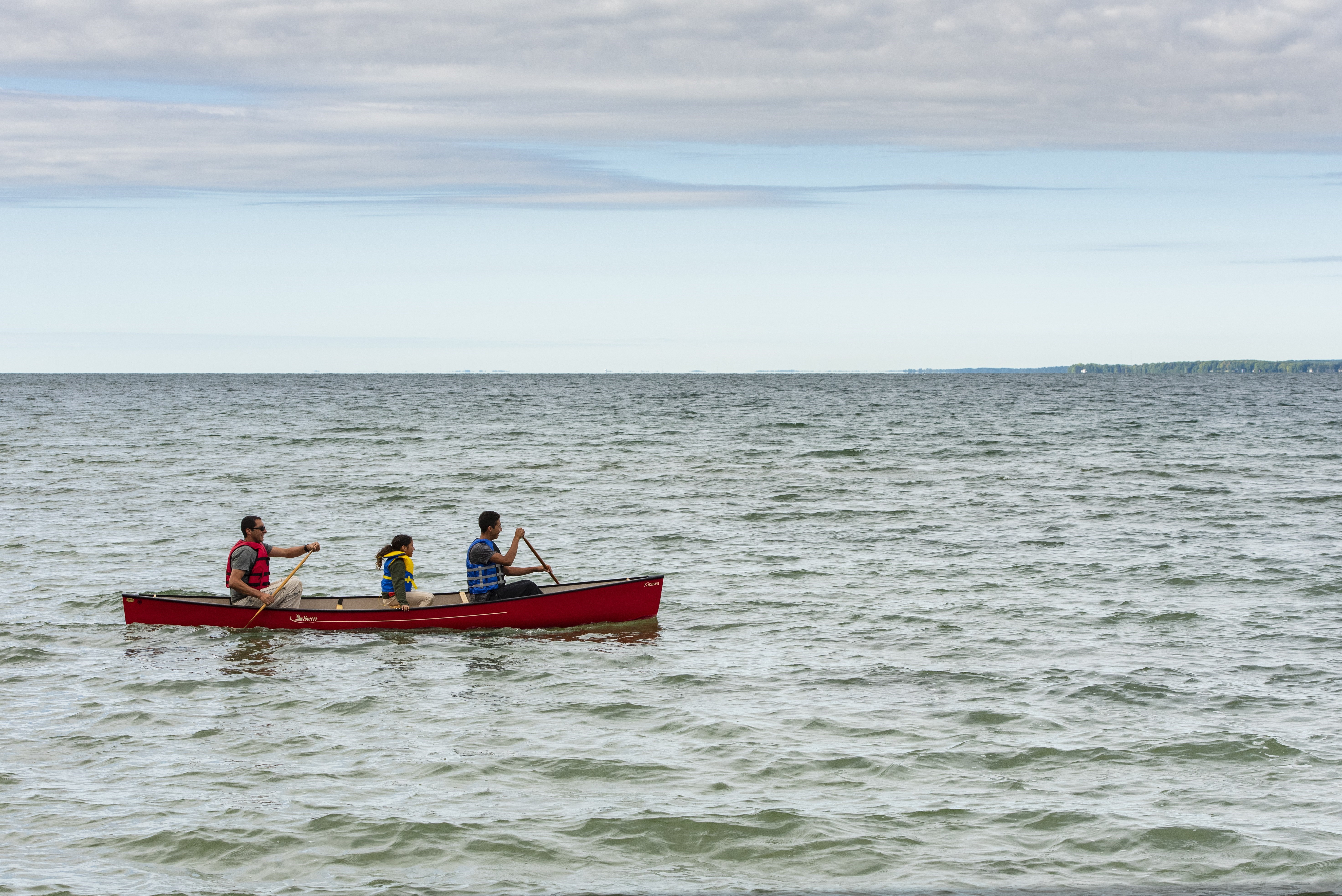 family paddling in a canoe