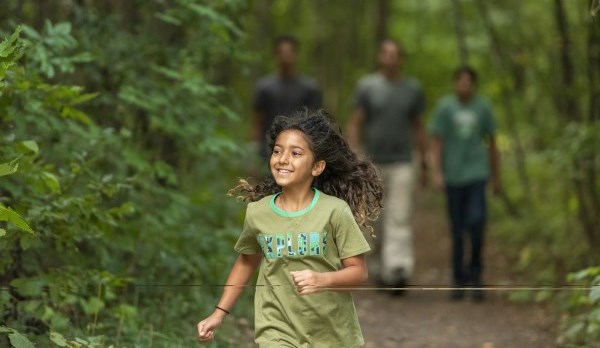 Picture of a girl running through a trail 