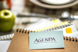 Agenda on table with an apple and pencil