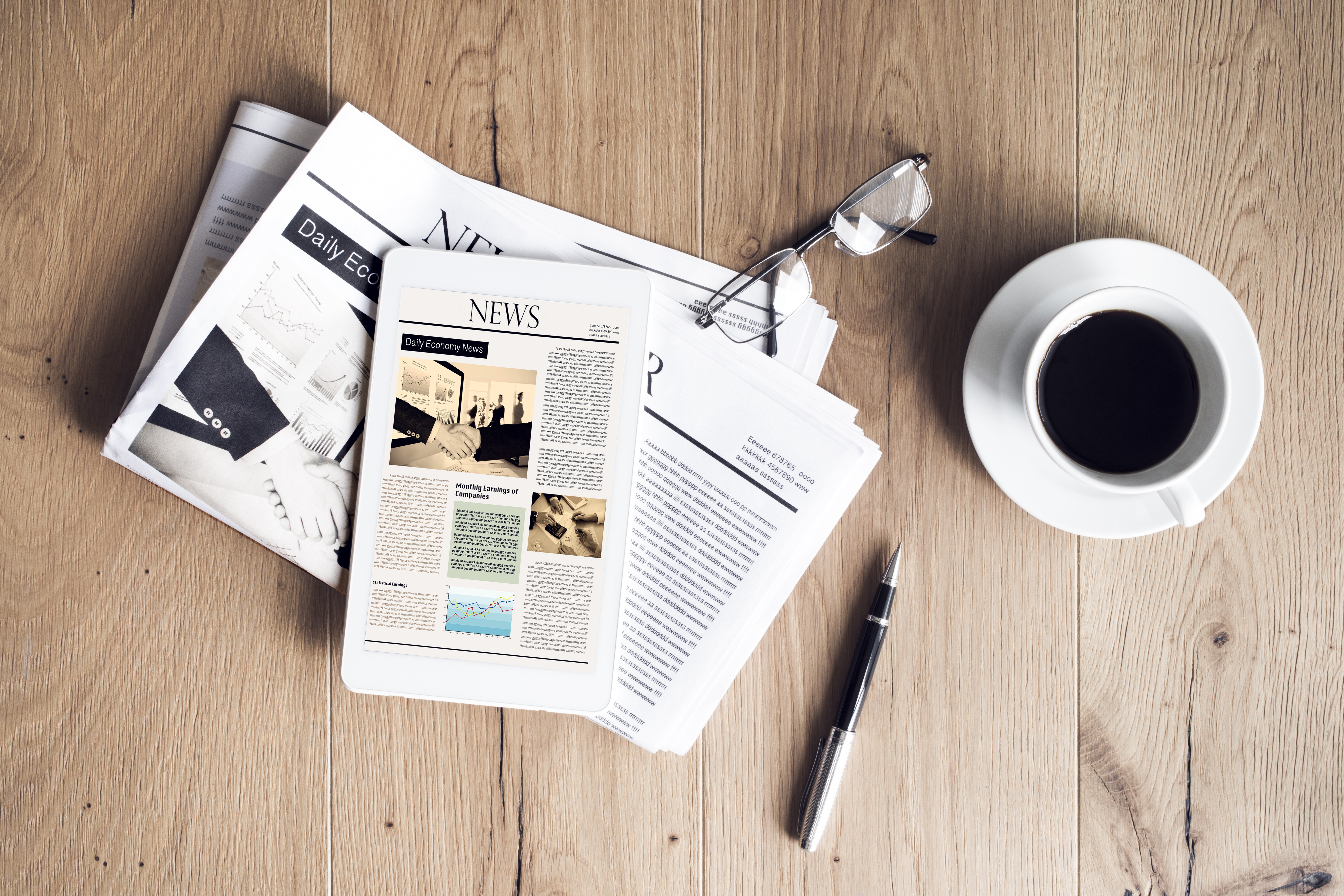 A picture of a newspaper and a coffee cup