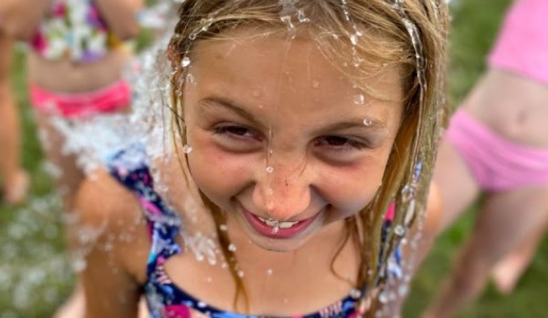 Picture of a girl with water being poured over her head