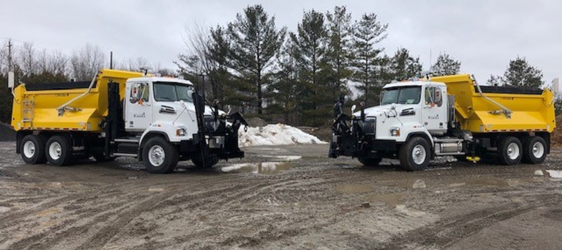 Picture of two plow trucks