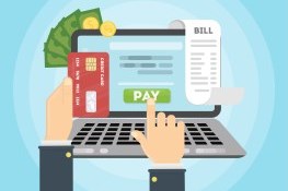 Person paying with a credit card and computer